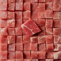 Raw cubed beef close-up pattern with singular offset piece in focus Royalty Free Stock Photo