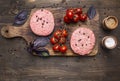 Raw cutlet for burgers, with cherry tomatoes and herbs on a cutting board, boarder, space text on wooden rustic background top