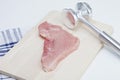 Raw cutlet and meat tenderizer