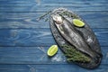 Raw cutthroat trout fish on blue wooden table. Space for text Royalty Free Stock Photo