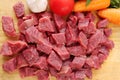 Raw cutting beef with vegetables on wooden plate