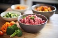 raw diced beef and vegetables prepped in separate bowls Royalty Free Stock Photo