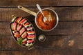 Raw dish ratatouille in pan on wooden table, top view Royalty Free Stock Photo