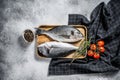 Raw Dorado fish with cooking ingredients, cherry tomatoes, thyme, pepper. Gray background. top view Royalty Free Stock Photo