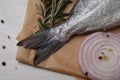 Raw dorado fish, spices and onion on white wooden table, flat lay