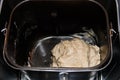 Raw dough in bread pan of electric bread maker Royalty Free Stock Photo