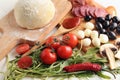 Raw dough and ingredients for pizza on table Royalty Free Stock Photo