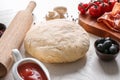 Raw dough with ingredients for pizza on table Royalty Free Stock Photo