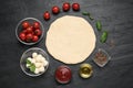 Raw dough and other ingredients for pizza on black table, flat lay Royalty Free Stock Photo