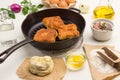 Raw dough on paper. Fried pies with meat in pan Royalty Free Stock Photo