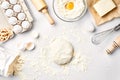 Raw dough ready for kneading on white table. Bakery ingredients, eggs, flour, butter. Shapes for making cookies.