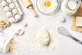 Raw dough ready for kneading on white table. Bakery ingredients, eggs, flour, butter. Shapes for making cookies. Royalty Free Stock Photo