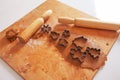 Raw dough and rolling pins for Christmas cookies. Cookie cutters - Christmas tree, snowflake, jingle bell, gingerbread man. Royalty Free Stock Photo