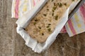 Raw dough for whole grain bread rising in form on a dish towel Royalty Free Stock Photo