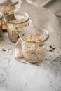 Raw dough of wholegrain bread with chia, oats, flaxseeds, sunflower and pumpkin seeds in glass jar for canning and prepper long