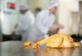 Raw dressed chicken lying on cutting table of butchers shop