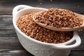 Raw buckwheat grains in white bowls