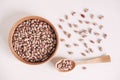 Raw dry beans in a wooden bowl with a spoon on a white background. Top view. Copy, empty space for text Royalty Free Stock Photo