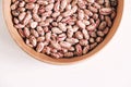 Raw dry beans in a wooden bowl on a white background. Top view. Copy, empty space for text Royalty Free Stock Photo