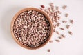 Raw dry beans in a wooden bowl on a white background. Top view. Copy, empty space for text Royalty Free Stock Photo