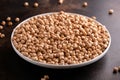 Raw dry chickpeas in plate on rustic table Royalty Free Stock Photo