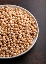 Raw dry chickpeas in plate on rustic table Royalty Free Stock Photo