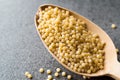 Raw Dry Organic Couscous in Wooden Spoon / Turkish Kuskus