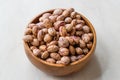 Raw Dry Pinto Beans on Marble Board with Wooden Bowl / Kidney Beans. Royalty Free Stock Photo