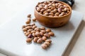 Raw Dry Pinto Beans on Marble Board with Wooden Bowl / Kidney Beans. Royalty Free Stock Photo