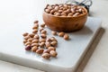 Raw Dry Pinto Beans on Marble Board with Wooden Bowl / Kidney Beans. Royalty Free Stock Photo