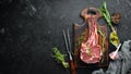 Raw dry steak tomahawk on a black background. Steak Cowboy. Barbecue. Top view. Royalty Free Stock Photo