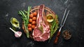 Raw dry steak tomahawk on a black background. Steak Cowboy. Barbecue. Top view. Royalty Free Stock Photo