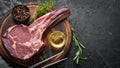 Raw dry steak tomahawk on a black background. Steak Cowboy. Barbecue. Top view. Royalty Free Stock Photo