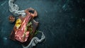 Raw dry steak tomahawk on a black background. Steak Cowboy. Barbecue. Top view. Royalty Free Stock Photo