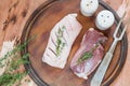 Raw duck breast on a cutting board with herbs and spices Royalty Free Stock Photo