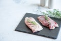 Raw duck breast on a cutting board with herbs and spices Royalty Free Stock Photo