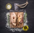 Raw duck breast with rice, butter and honey, and rosemary on a cutting board wooden rustic background top view close up