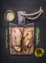 Raw duck breast with rosemary, honey and butter cutting board wooden rustic background top view close up