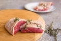 Raw duck breast with thyme on wooden tray Royalty Free Stock Photo