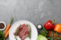 Raw duck breast in white plate with vegetables Royalty Free Stock Photo