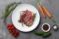 Raw duck breast in white plate with vegetables Royalty Free Stock Photo