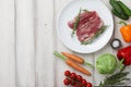 Raw duck breast in white plate and vegetables Royalty Free Stock Photo