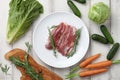 Raw duck breast in white plate and vegetables Royalty Free Stock Photo