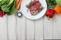 Raw duck breast in white plate and vegetables Royalty Free Stock Photo