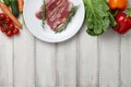 Raw duck breast in white plate and vegetables Royalty Free Stock Photo