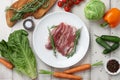 Raw duck breast in white plate and vegetables Royalty Free Stock Photo