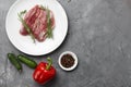 Raw duck breast in white plate with vegetables Royalty Free Stock Photo