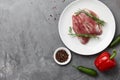 Raw duck breast in white plate with vegetables Royalty Free Stock Photo