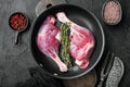 Raw duck leg thighs, on frying cast iron pan, on black stone background, top view flat lay Royalty Free Stock Photo