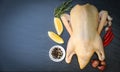 Raw duck with spices ready to cook on black background , fresh duck meat on plate for food , whole duck and lemon rosemary chili Royalty Free Stock Photo